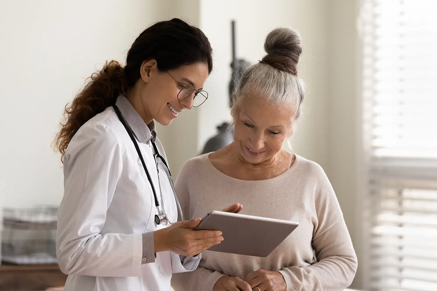 A doctor smiling while showing test results to a patient