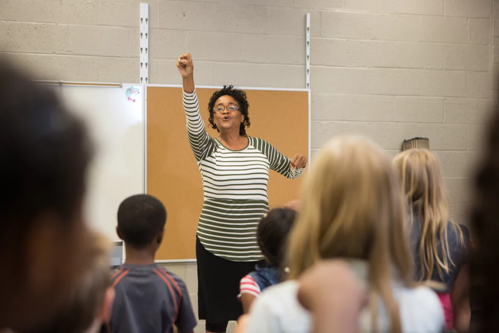 Instructor conducting during music class at Pond Gap